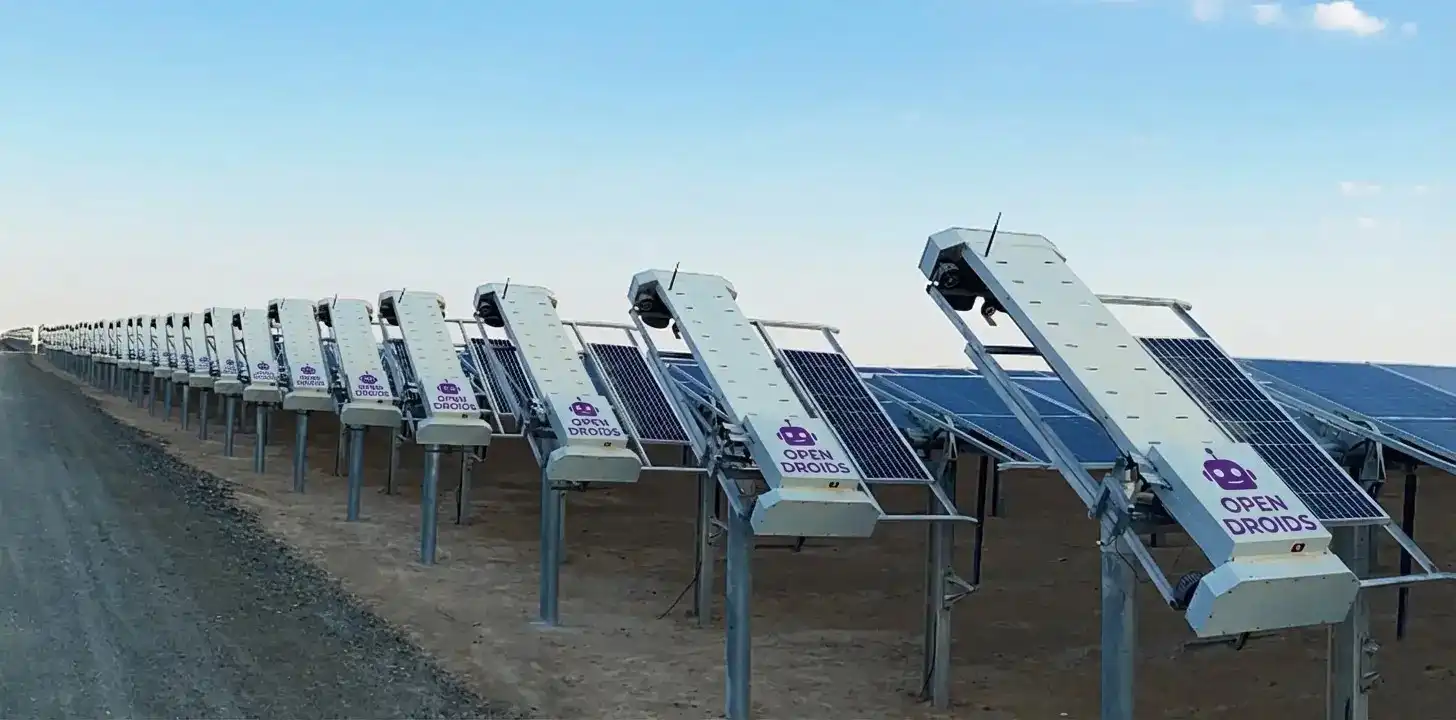 Corporate office park with sleek mower working, person reading on bench nearby undisturbed