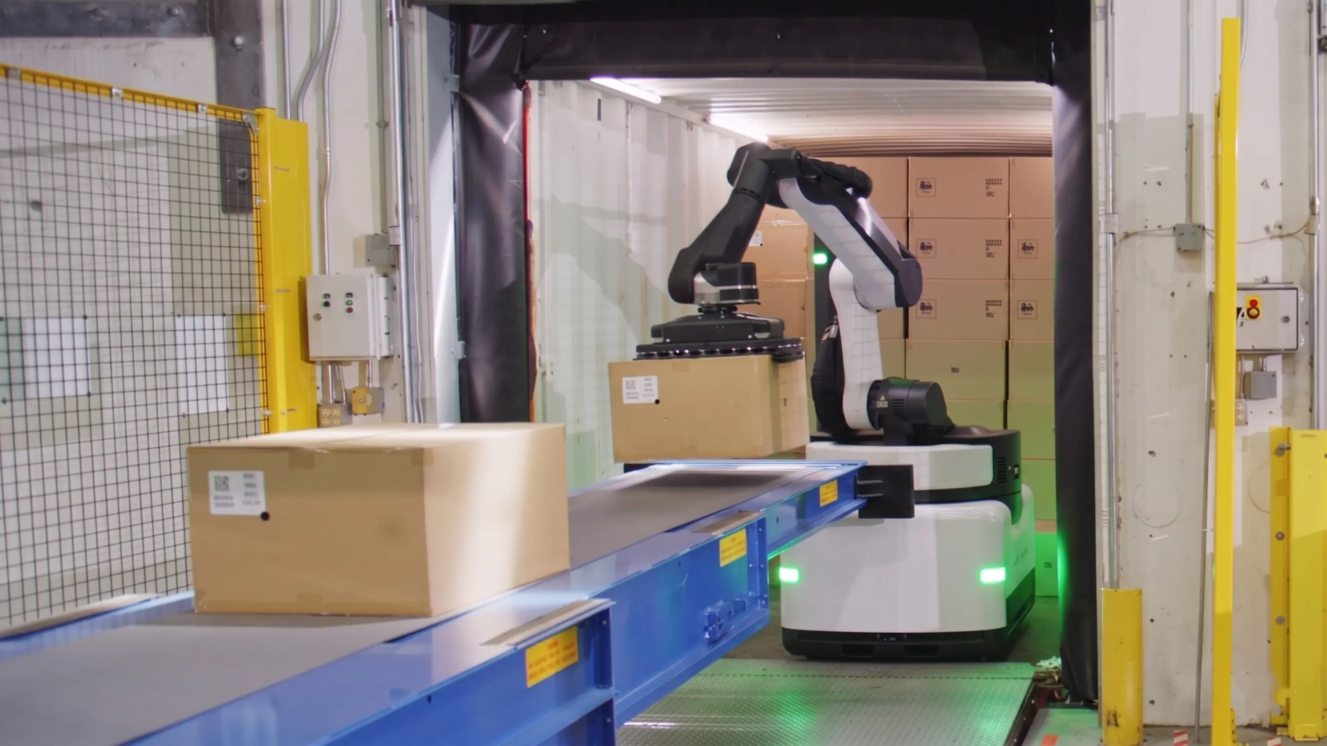 OpenDroids tugger AMR pulling a loaded cart train down a warehouse aisle